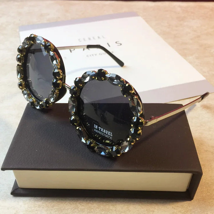 Sunglasses with decorative frame on a book
