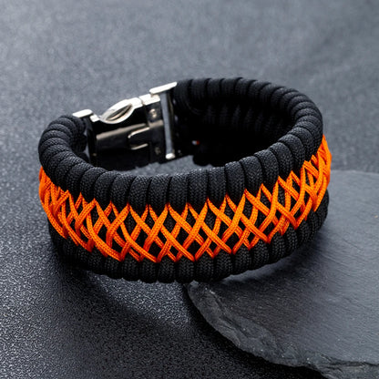 Black and orange braided bracelet on a dark grey background