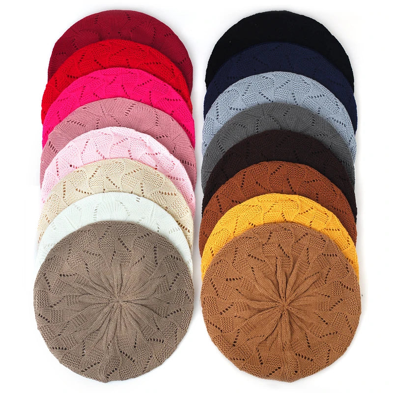 Collection of colourful knit berets arranged in a pattern on a white background