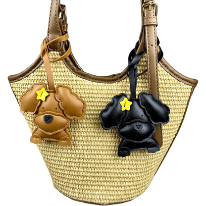 Woven handbag with dog-shaped charms on a white background