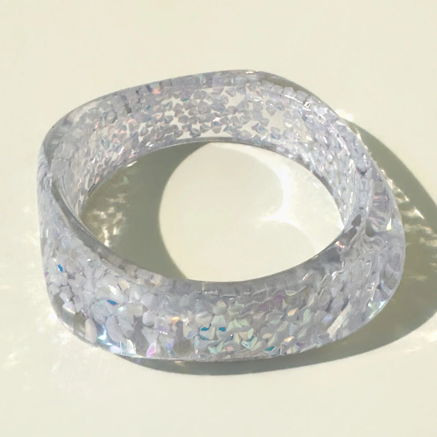 Clear glittery bangle on a light background