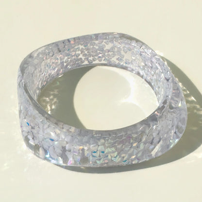 Clear glittery bangle on a light background