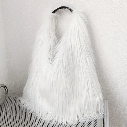 White fur handbag on a trolley against a white wall.