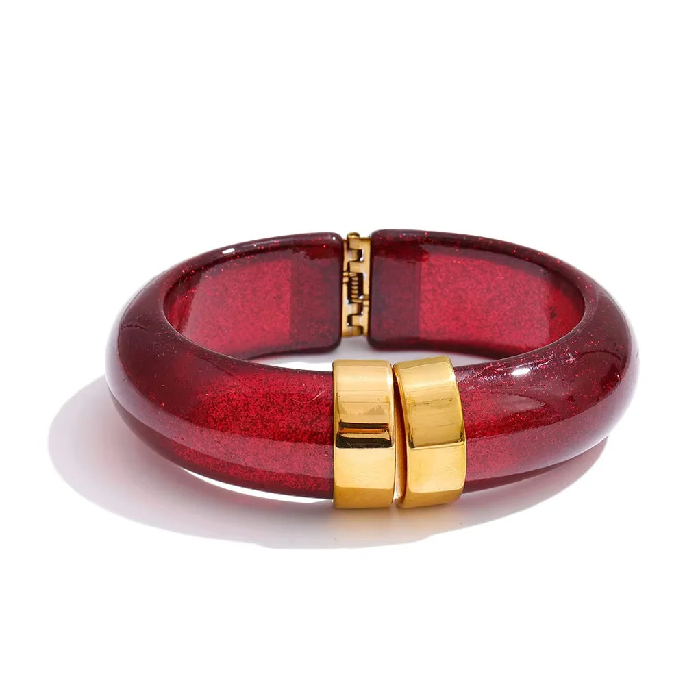 Red bracelet with gold clasp on a white background