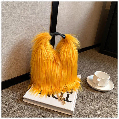 Yellow furry handbag on a book with a cup and saucer in the background
