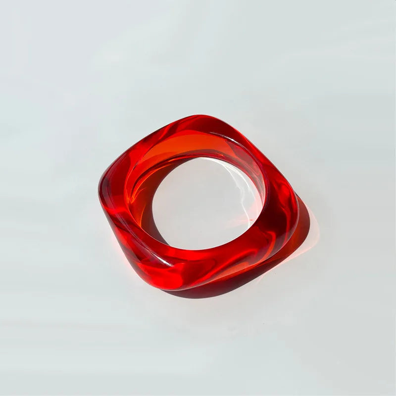 Red and clear bangle on a light grey background