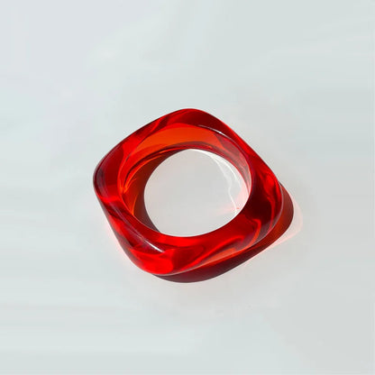Red and clear bangle on a light grey background