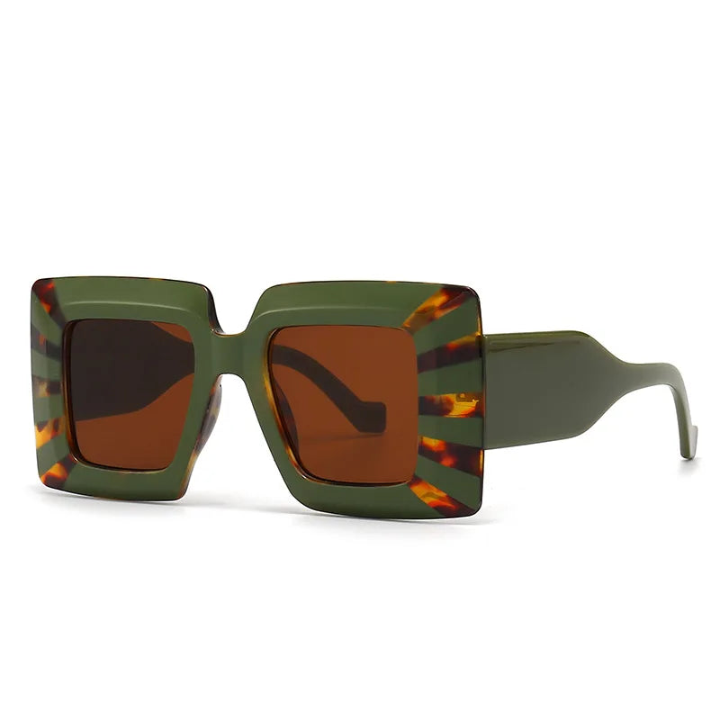Sunglasses with green frame and tortoiseshell accents on a white background