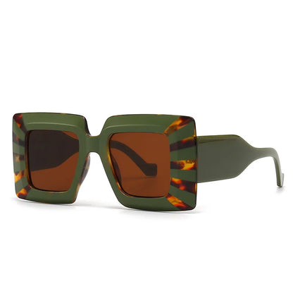 Sunglasses with green frame and tortoiseshell accents on a white background