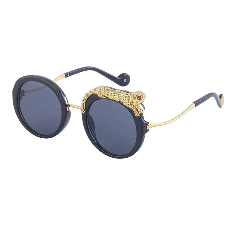 Sunglasses with gold accents and black frames on a white background