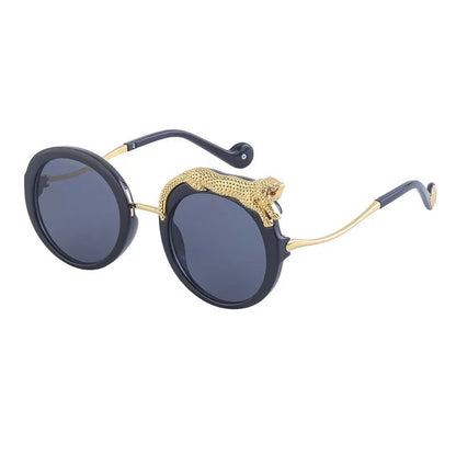 Sunglasses with gold accents and black frames on a white background