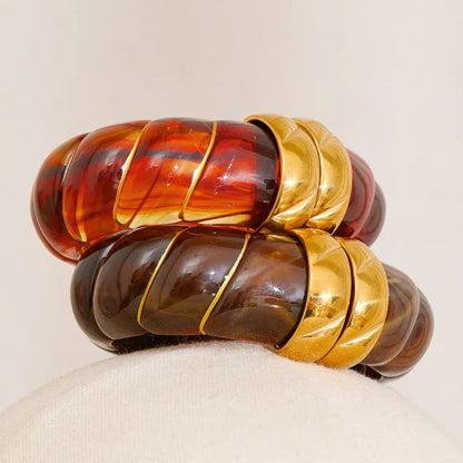 Stack of colourful bangles on a beige background