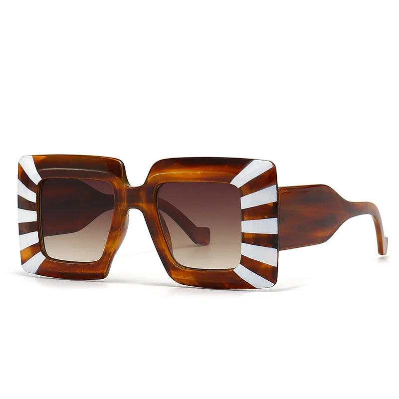 Sunglasses with tortoiseshell frame and white stripes on a white background