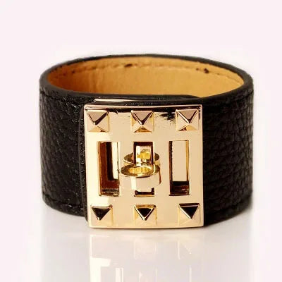 Black leather bracelet with gold clasp on a white background