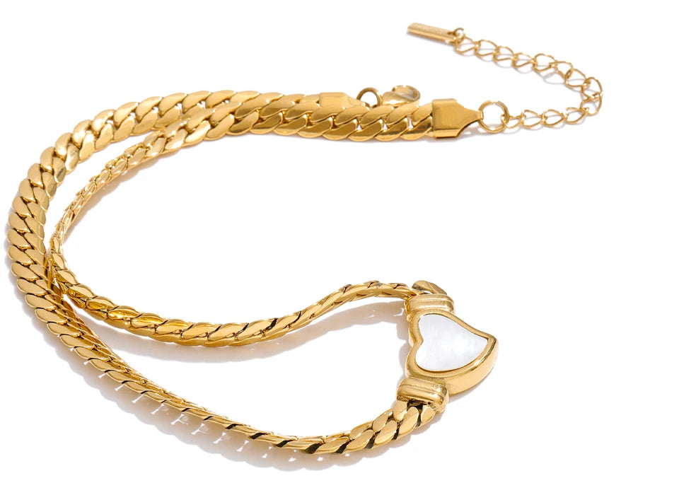 Gold chain bracelet with a heart-shaped clasp on a white background