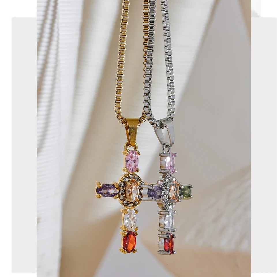 Colourful cross pendant necklace on a white background