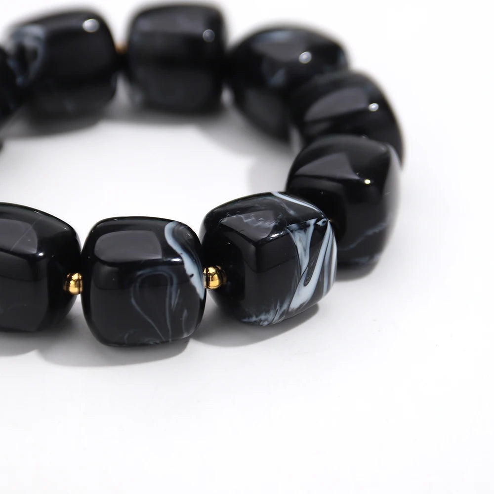Black marbled bead bracelet on a white background