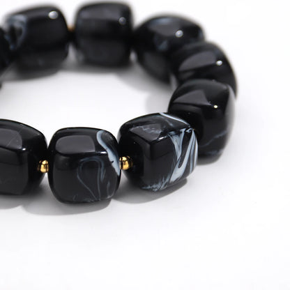 Black marbled bead bracelet on a white background