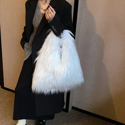 Person holding a white feathered bag against a plain background