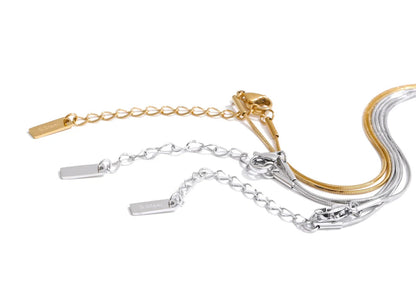Gold and silver bracelets on a white background