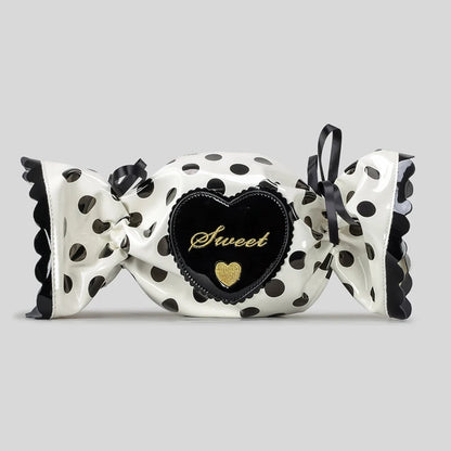 Decorative candy bag with polka dot design and heart-shaped 'Sweet' label on a grey background