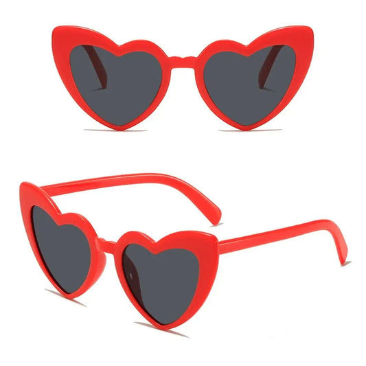 Red heart-shaped sunglasses with dark lenses on a white background