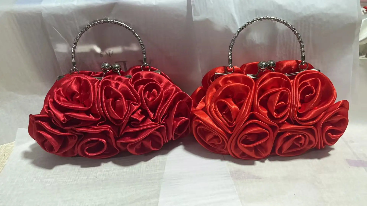 Two red rose-shaped handbags on a white background