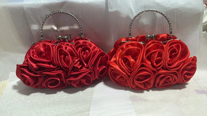 Two red rose-shaped handbags on a white background