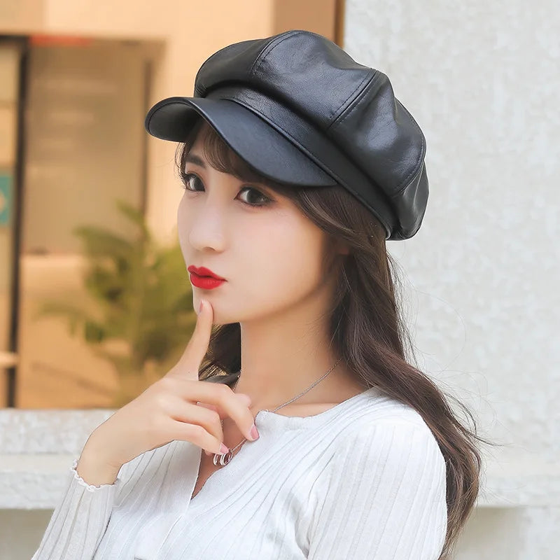 Woman wearing a black leather cap with a blurred indoor background
