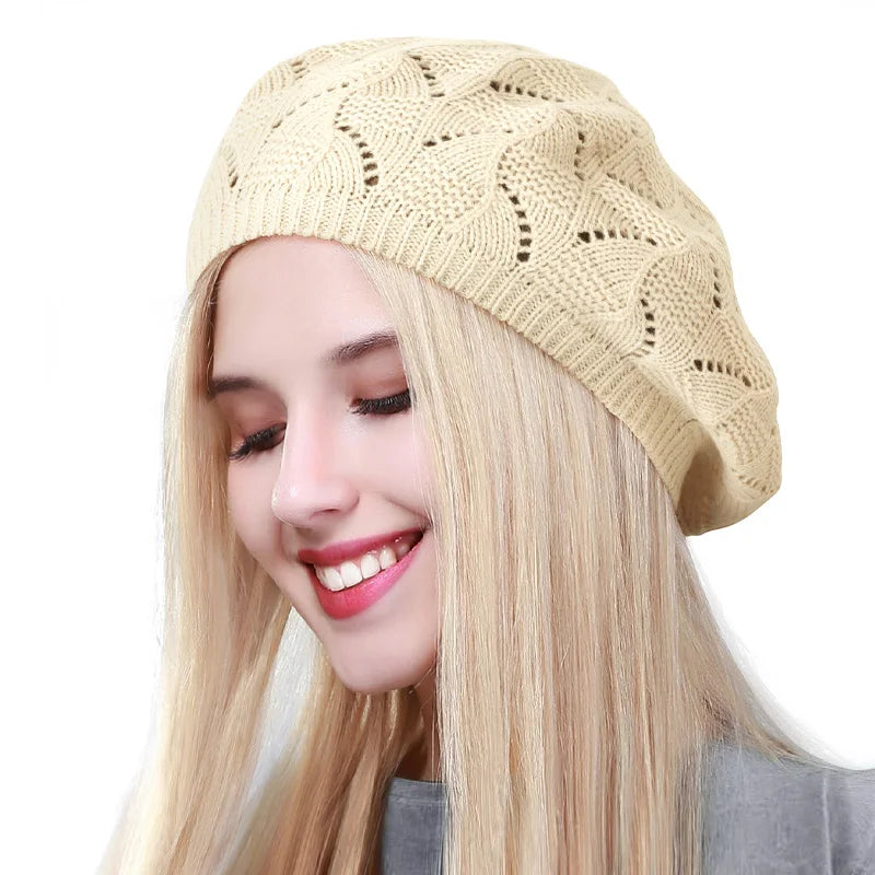 Woman wearing a beige knitted beret on a white background