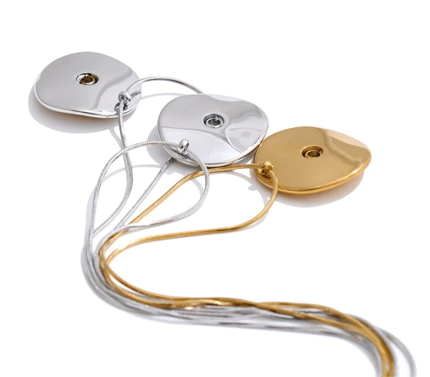 Gold and silver pendant necklaces on a white background