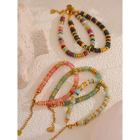 Colourful beaded necklaces on a textured surface