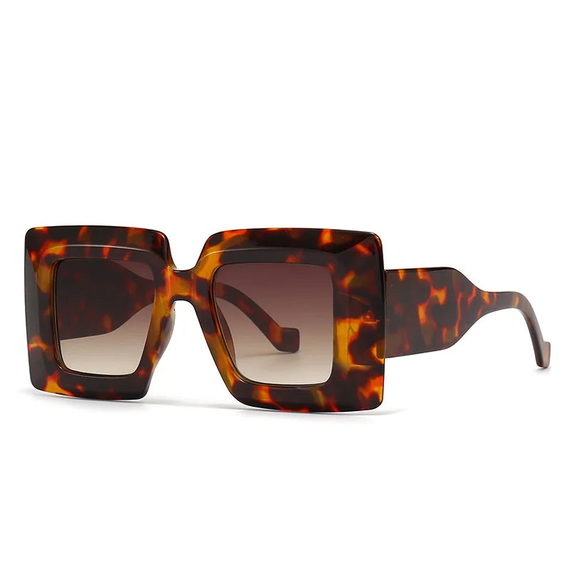 Tortoiseshell sunglasses with brown lenses on a white background