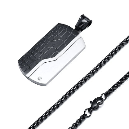 Black and silver pendant with chain on a white background