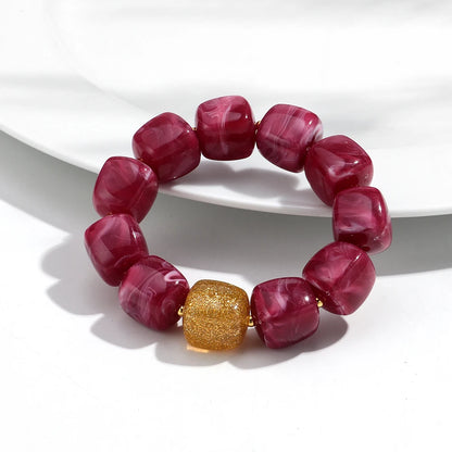 Bracelet with pink beads and a gold clasp on a white background