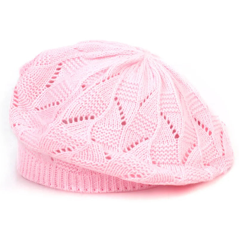 Pink knitted hat on a white background