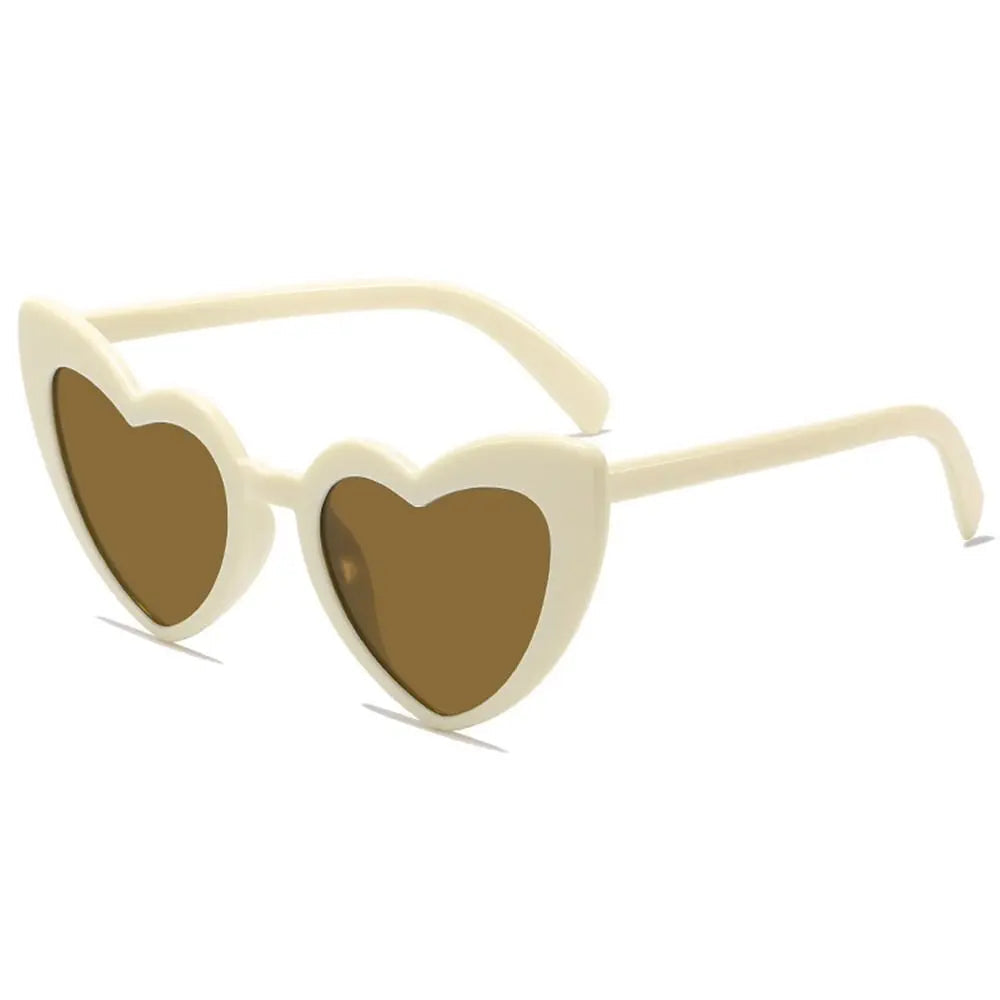 Beige heart-shaped sunglasses on a white background