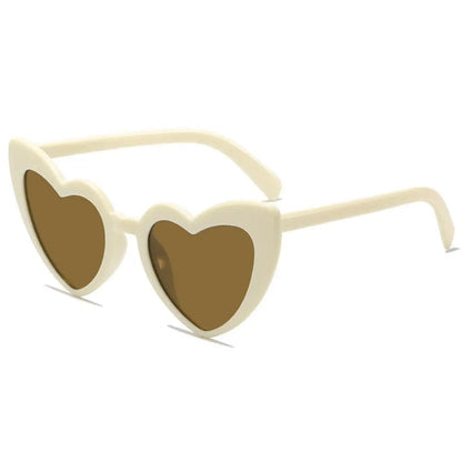 Beige heart-shaped sunglasses on a white background
