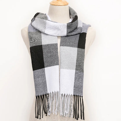 Plaid scarf with black, white, and grey pattern on a mannequin against a white background