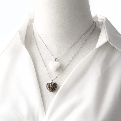 Necklace with heart pendant on a white shirt