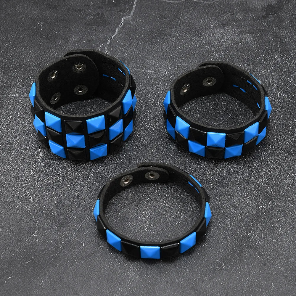 Three black and blue checkered bracelets on a dark textured surface