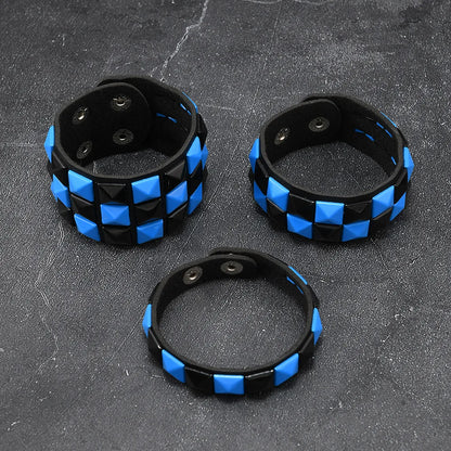 Three black and blue checkered bracelets on a dark textured surface