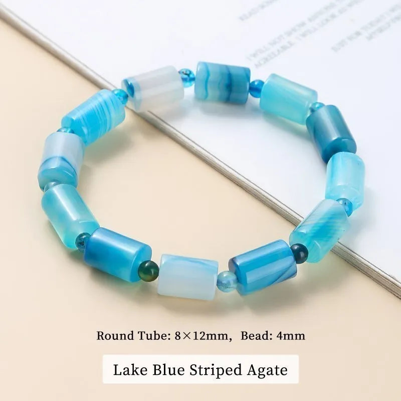 Lake Blue Striped Agate bracelet on a light beige surface with text indicating bead dimensions.