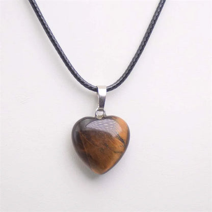 Heart-shaped pendant on a black cord against a white background