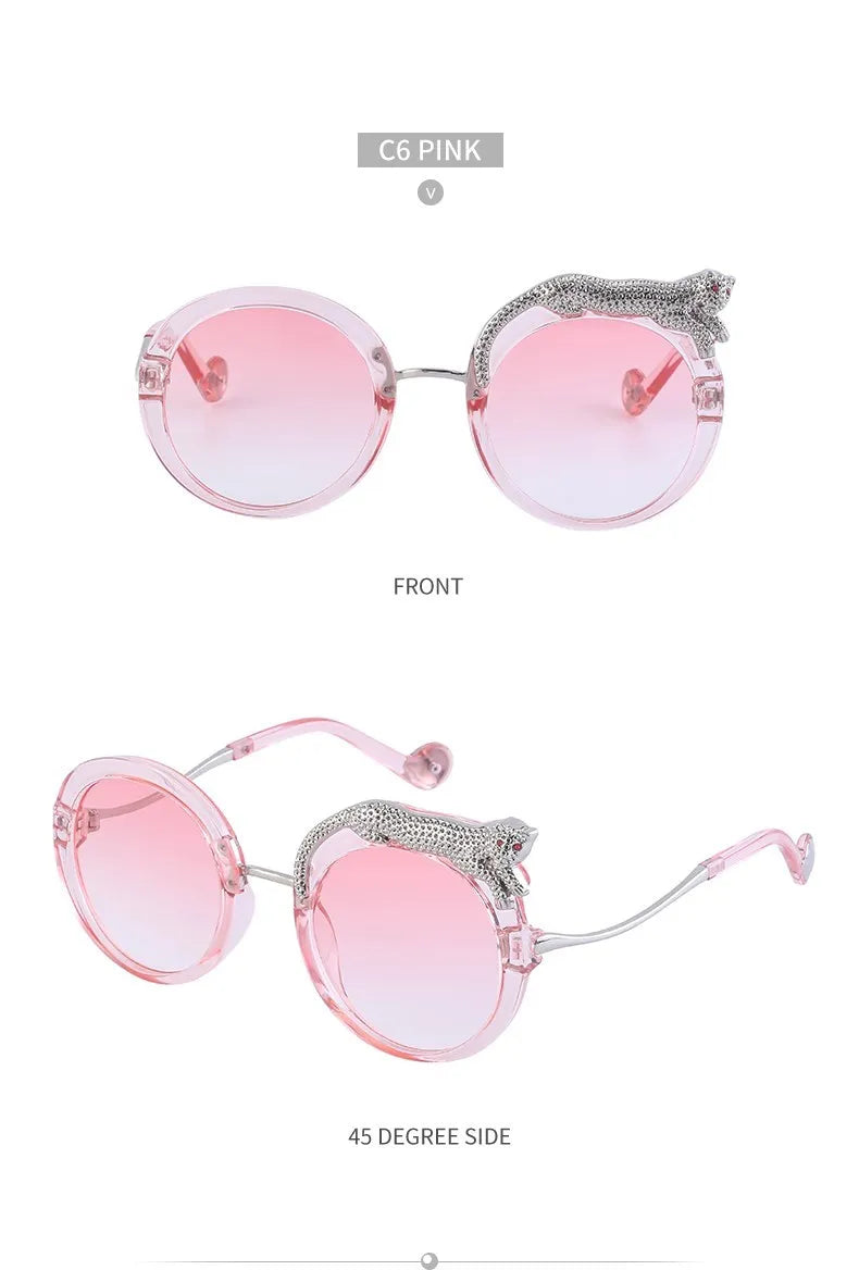 Pink sunglasses with rhinestone detailing on a white background