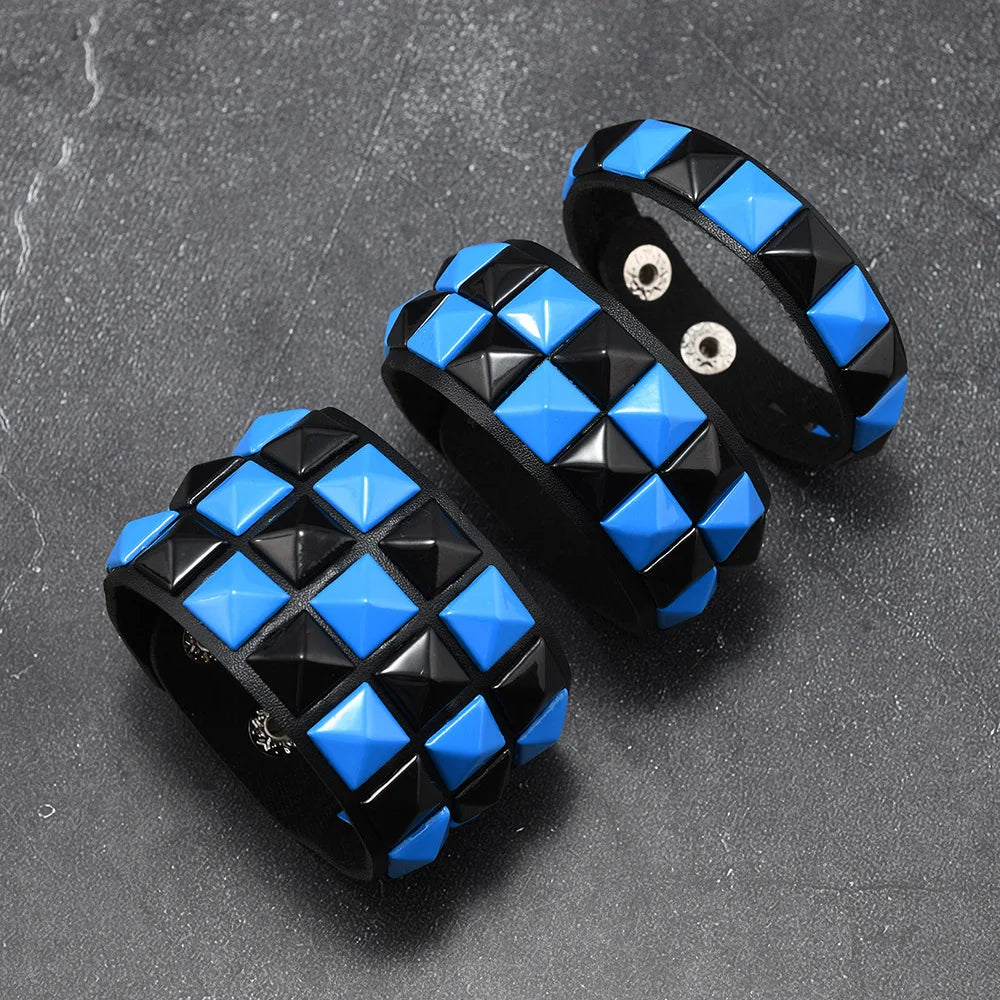 Three black and blue checkered bracelets on a grey surface