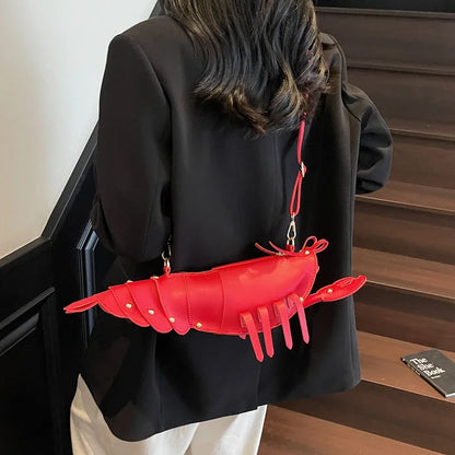 Person wearing a black coat with a red lobster-shaped bag over their shoulder.