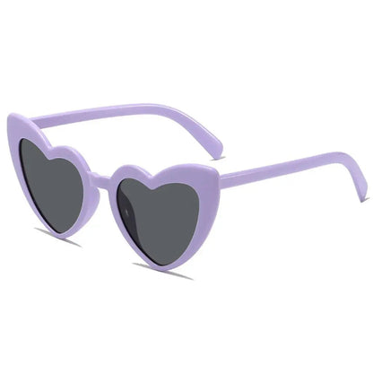 Heart-shaped purple sunglasses with dark lenses on a white background