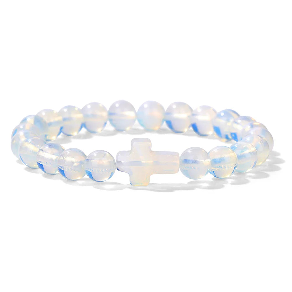 Opalite beaded bracelet with a cross charm on a white background