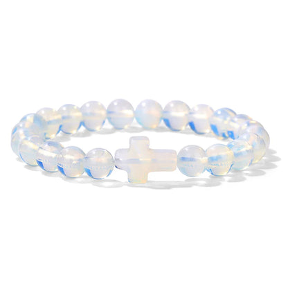 Opalite beaded bracelet with a cross charm on a white background